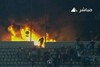 Кадр с картинкой одного из местных телеканалов, показывающий пожар на арене
