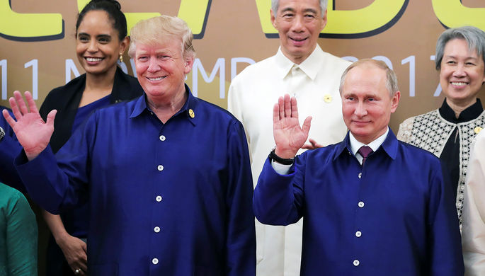 Президент США Дональд Трамп и президент России Владимир Путин пожимают руки во время встречи на...