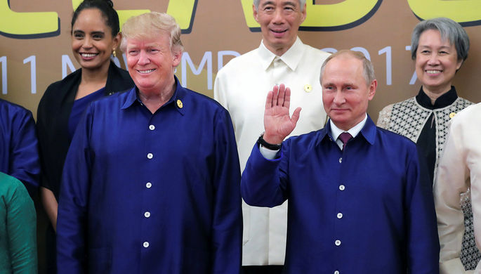 Президент США Дональд Трамп и президент России Владимир Путин пожимают руки во время встречи на...