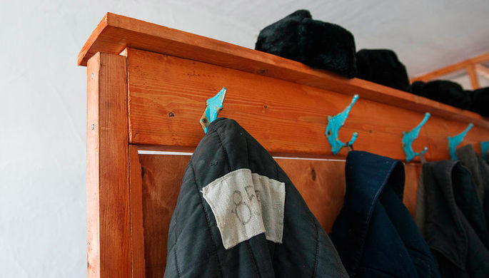 Prisoners' clothes are kept in a barrack where prisoners lived which is part of a museum...