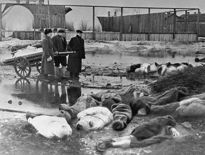 Мужчины хоронят умерших в дни блокады в Ленинграде. Волково кладбище.