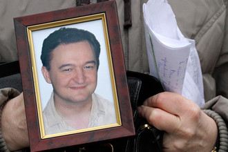 Портрет умершего в СИЗО юриста Сергея Магнитского в руках его матери Натальи во время интервью в Москве, 2009 год