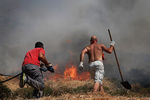 Местные жители тушат лесной пожар в деревне Неаполи в области Лакония на полуострове Пелопоннес