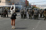 Полицейские и участница акции протеста в честь Международного женского дня в Вальпараисо, Чили, 8 марта 2021 года