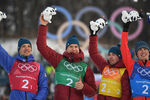 Андрей Ларьков, Александр Большунов, Алексей Червоткин и Денис Спицов (слева направо), завоевавшие серебряные медали в эстафете 4x10 км среди мужчин в соревнованиях по лыжным гонкам на XXIII зимних Олимпийских играх