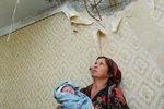 Жительница Грозного в своей квартире, в которую попала авиабомба