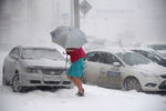 Девушка идет по улице во время сильного снегопада в Челябинске