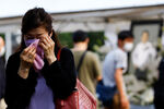 Женщина плачет во время похорон бывшего премьер-министра Японии Синдзо Абэ, Токио, 12 июля 2022 года
