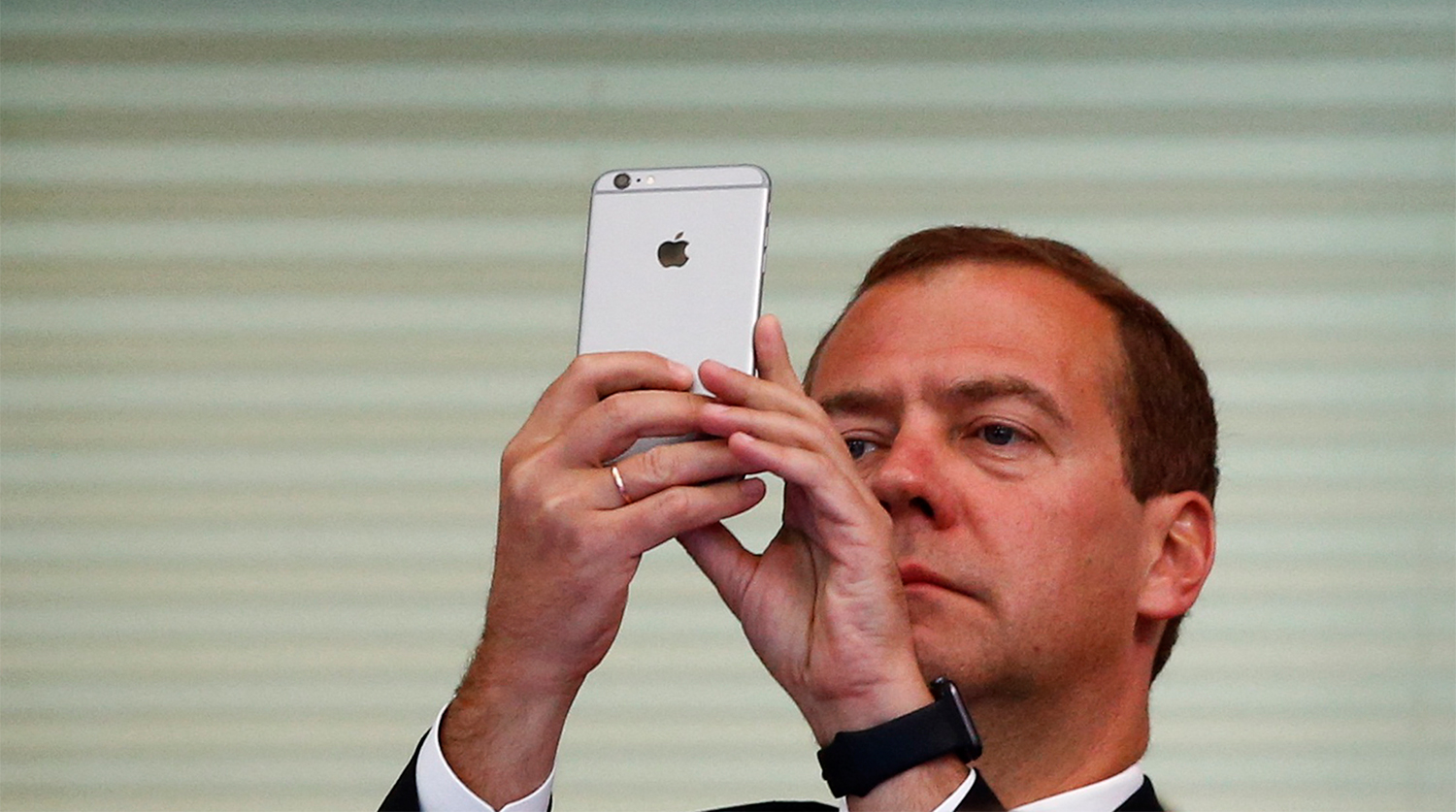 Дмитрий Медведев со смартфоном Apple во время чемпионата мира по водным видам спорта в Казани, 2015 год