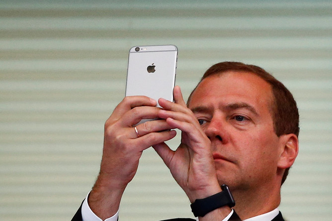 Дмитрий Медведев со смартфоном Apple во время чемпионата мира по водным видам спорта в Казани, 2015 год