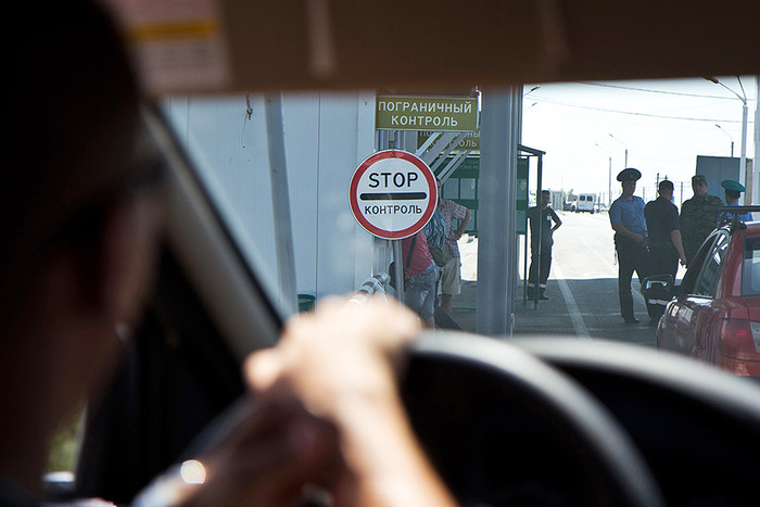 Сотрудники пограничной службы и полиции досматривают автомобильный транспорт на пункте пропуска «Армянск» российско-украинской границы