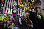 Полицейские у ворот Букингемского дворца, куда люди приносят цветы после сообщения о смерти королевы Елизаветы, 8 сентября 2022 года