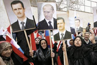 Сирийцы с портретами Владимира Путина и Башара Асада в Дамаске на митинге 15 сентября 2013 года