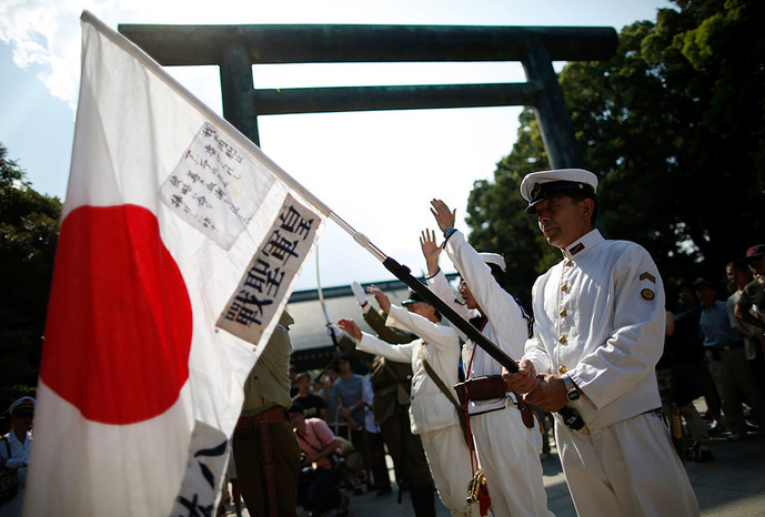 Солдаты в&nbsp;форме императорской армии поднимают флаги Японии во время мемориальной церемонии в&nbsp;храме Ясукуни в&nbsp;Токио, 15&nbsp;августа 2015&nbsp;года