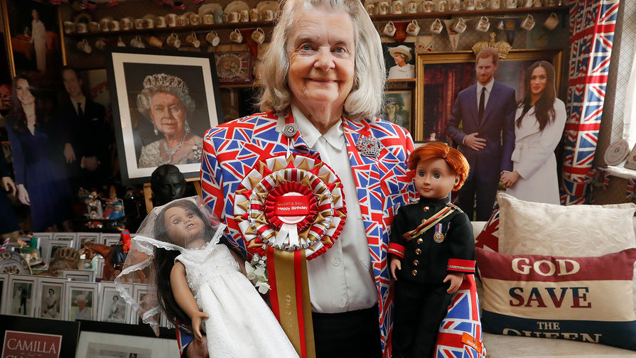 Поклонница королевской семьи Маргарет Тайлер позирует с&nbsp;куклами принца Гарри и Меган Маркл 