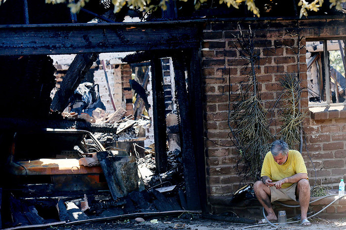Местный житель осматривает свой сгоревший дом, Карлсбад, Калифорния