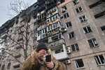 A resident of a house on the outskirts of Mariupol tries to contact, March 2022