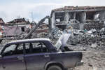 Destroyed houses and a broken car in Mariupol, March 2022