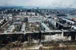 Destroyed houses on Kuprina Street (foreground) in March 2022, Mariupol