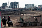 Мирные жители на фоне разрушенного города, февраль 2000 года