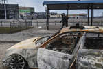 A broken car at a bus stop on the outskirts of Mariupol, March 2022