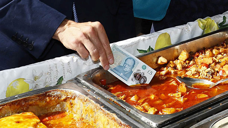 Глава Банка Англии Марк Карни показывает журналистам преимущества новой пластиковой банкноты перед обычной из бумаги