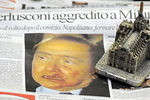 Газета с фотографией Берлускони, где ему попали в лицо статуэткой в виде церкви, 2009 год
