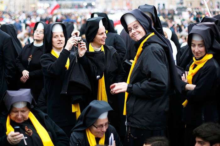 Монахини делают фотографии, ожидая начала церемонии канонизации на&nbsp;площади Святого Петра в&nbsp;Ватикане