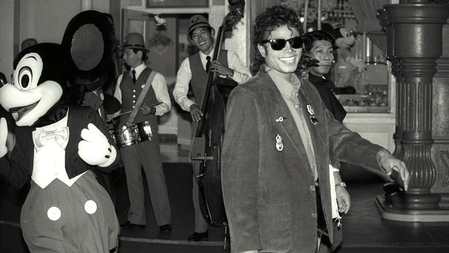 Певец Майкл Джексон в сопровождении Микки Мауса во время посещения Диснейленда в Токио, 1987 год
