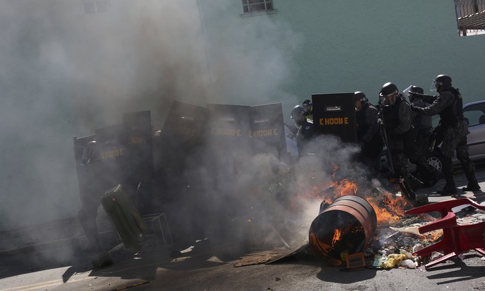 Протестующие пытаются остановить полицию, поджигая мусор