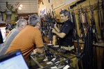 Владелец магазина Bullet Hole во Флориде Брук Мисантон показывает покупателям две последние винтовки AR-15.