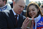 Президент России Владимир Путин и олимпийская чемпионка в&nbsp;фигурном катании Аделина Сотникова во время церемонии фотографирования с&nbsp;российскими призерами XXII зимних Олимпийских игр в&nbsp;Сочи, 2014 год
