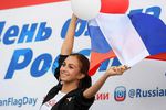 Участница праздничных мероприятий, приуроченных к празднованию Дня государственного флага Российской Федерации, в парке аттракционов Кырлай в Казани, 22 августа 2018 года