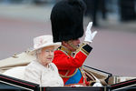 Королева Великобритании Елизавета и принц Филипп возвращаются в Букингемский дворец в карете после посещения церемонии 