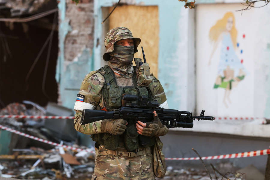 Военнослужащий у школы на Зеленой улице, здание которой пострадало в результате обстрела ВСУ, Донецк, 13 июня 2022 года