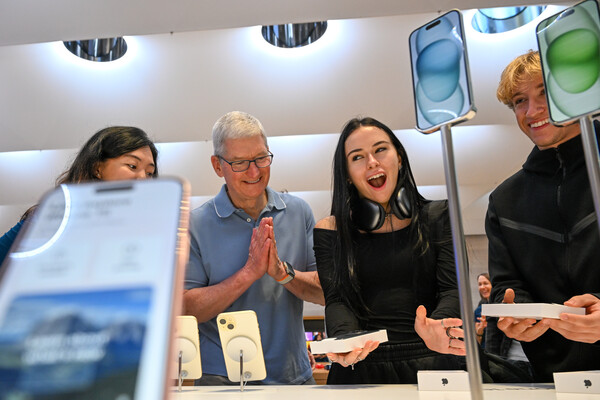 Генеральный директор Apple Тим Кук (слева) и первые покупатели нового iPhone 15&nbsp;во время презентации в&nbsp;Apple Store на&nbsp;Пятой авеню в&nbsp;Нью-Йорке, 22&nbsp;сентября 2022&nbsp;года