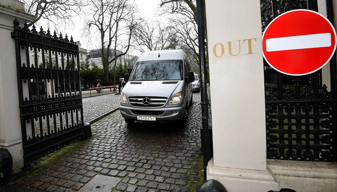 Микроавтобус с дипломатами и их семьями во время выезда с территории российского посольства в...