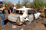 Сгоревший автомобиль на месте гибели фотокорреспондента Андрея Стенина

