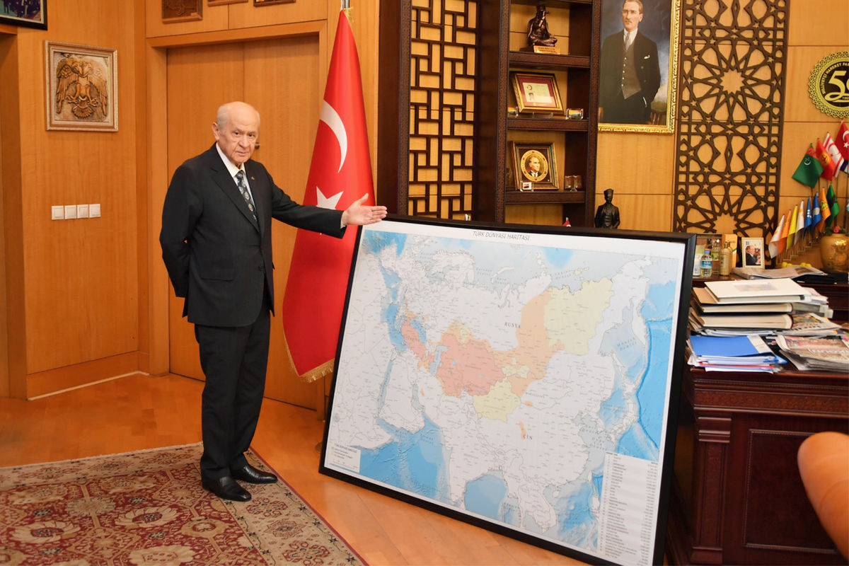 Лидер турецкой парламентской Партии националистического движения Девлет Бахчели рядом с картой «турецкого мира»