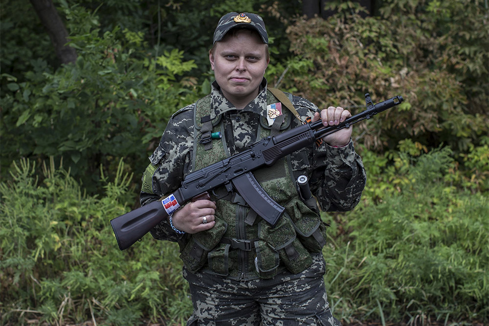Женщина, воюющая на стороне ополченцев, позирует с винтовкой в Донецке
