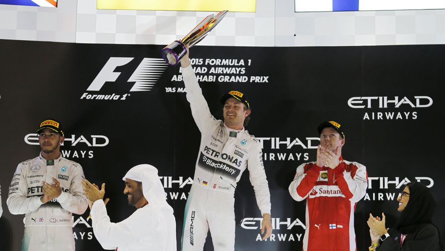 Нико Росберг (в центре) радуется на подиуме в Абу-Даби третьей победе подряд на финише сезона